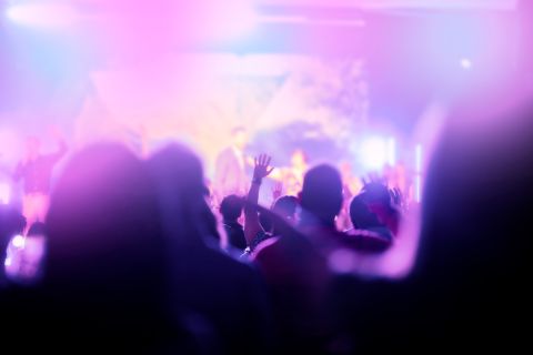 Colorful fuzzy photo of a modern evangelical worship service to illustrate the article 
